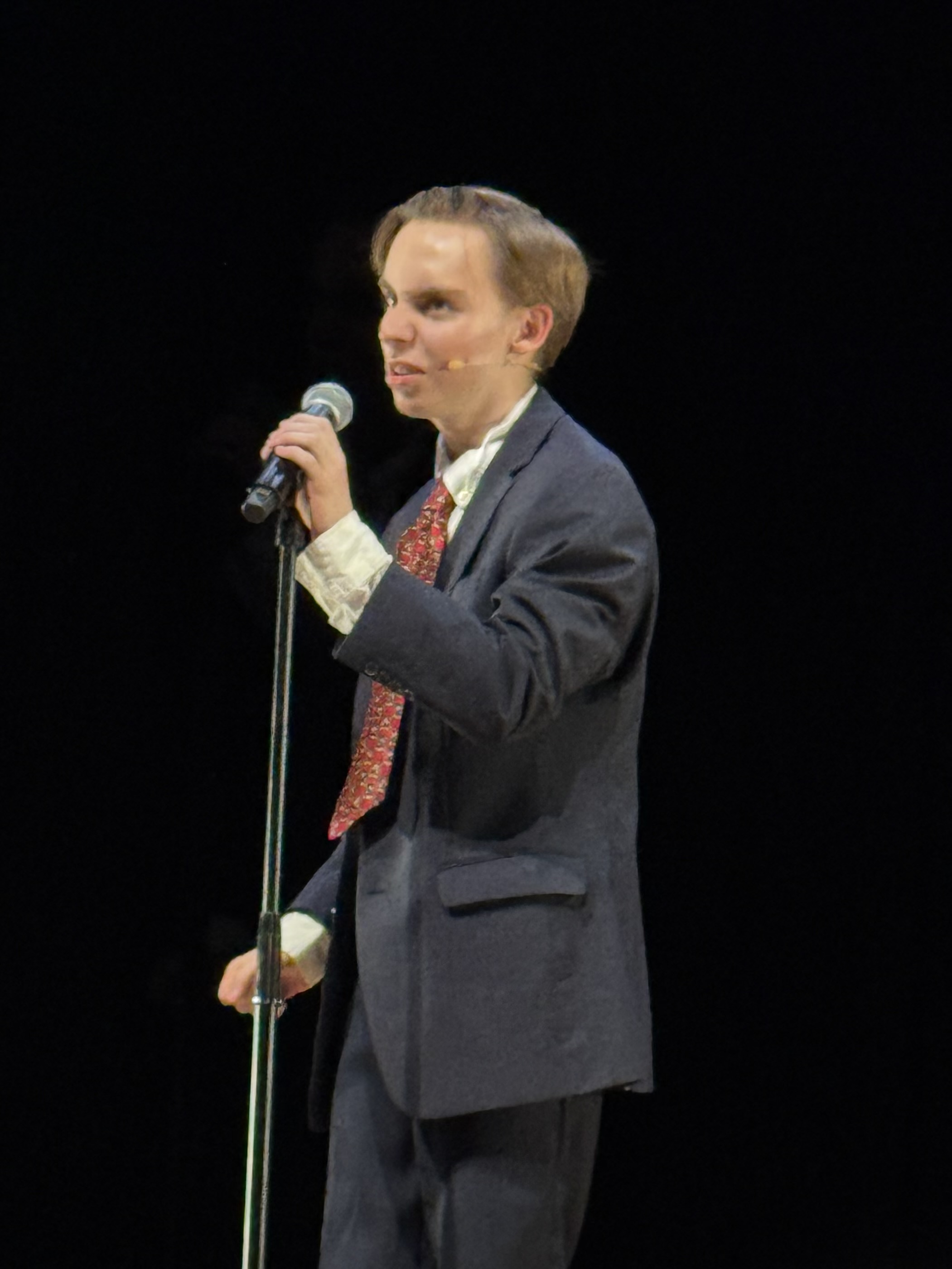 Van at the mic in a suit and tie