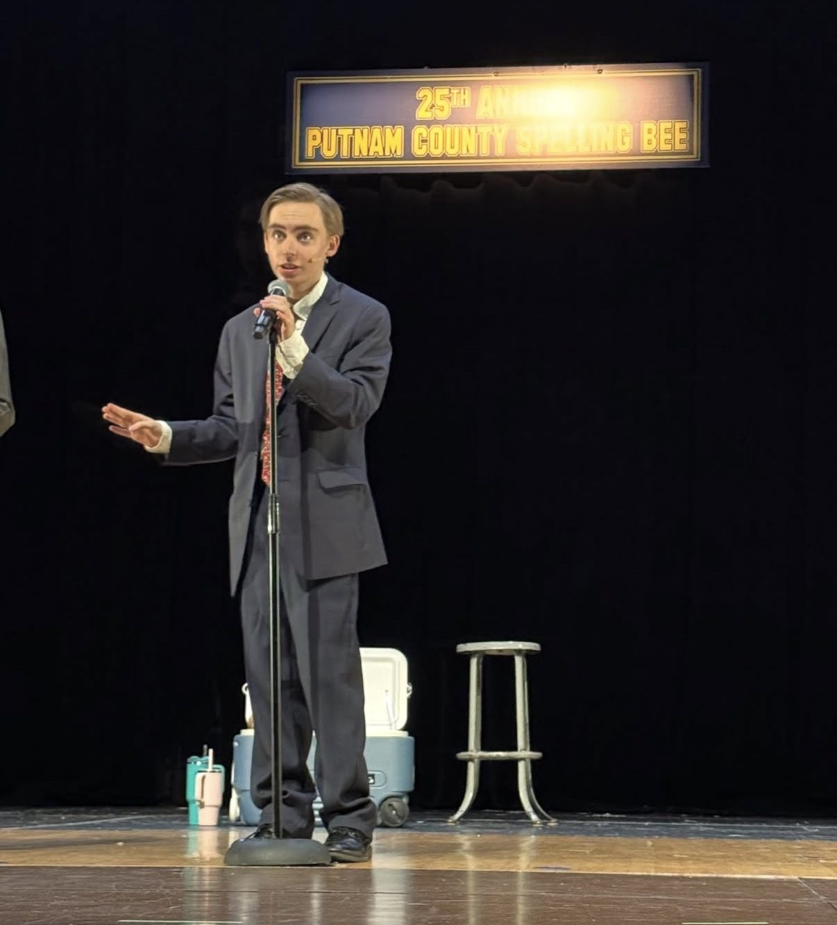 Van alone on stage during a Spelling Bee scene