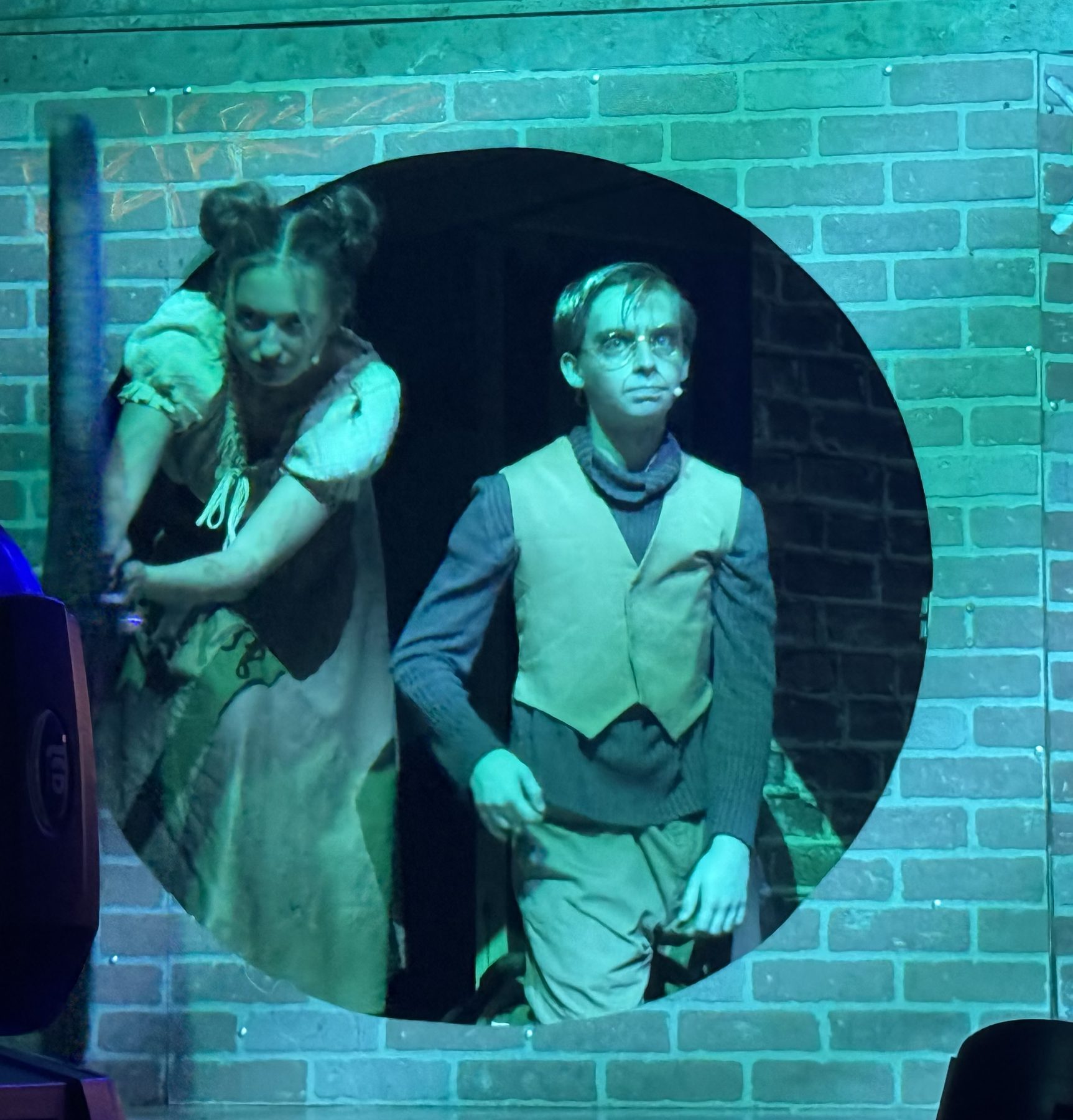 Two-character scene under teal light